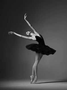 a ballerina in black and white poses for the camera