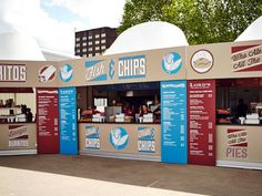 an outdoor food stand with lots of menus on it