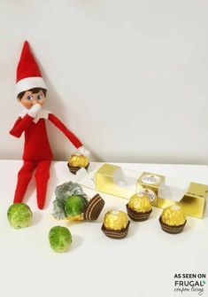 an elf is sitting next to some chocolates