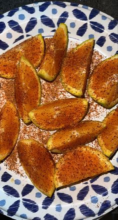 a white and blue plate topped with sliced up squash