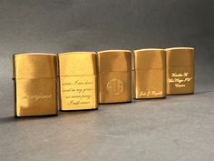 four different types of gold colored lighters with writing on the front and back sides