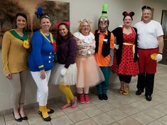 a group of people standing next to each other wearing costumes and holding tennis racquets