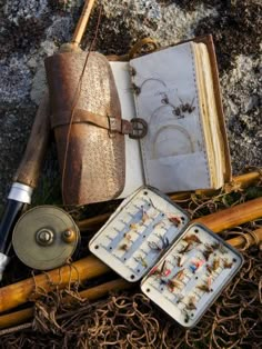 an open book sitting on top of a wooden table next to other items and tools