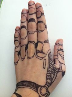 a person's hand with tattoos on it