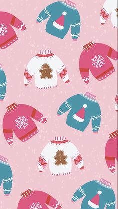 a pink and blue sweater with gingerbreads on it is shown in the background