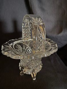 a clear glass candle holder sitting on top of a table