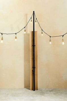 a wooden pole with some lights hanging from it's sides and on top of it