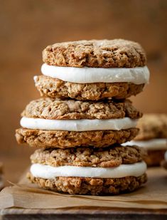 three oatmeal cookies stacked on top of each other with icing and marshmallows