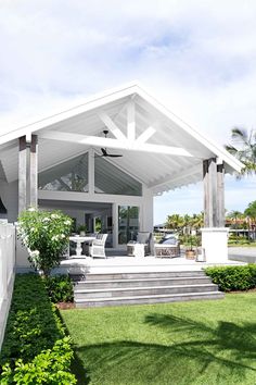 a white house with a covered porch and steps leading up to the front door area