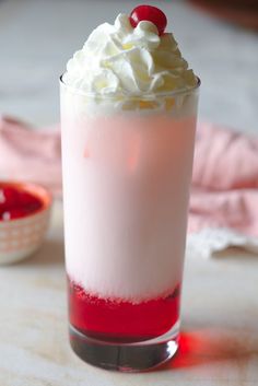 a drink with whipped cream and cherries on top