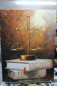 a painting of a balance scale on top of a book and some paintbrushes