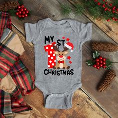 Adorable Christmas Baby Boy or Girl Onesie with My 1st Christmas Reindeer Graphic Print available at Trendy Custom Apparel! Buy our 100% soft cotton Gerber or Rabbit Skins pre-shrunk brands with multiple color designs and bright soft flex vinyl colors. Perfect for your baby boy’s or girl’s first Christmas, comes with an adorable reindeer for matching gender, great for twins first Christmas outfits. Colors available in are Black, Gray and White. Shop your favorite onesie in Christmas Baby ... Twins First Christmas, Christmas Onsies, Reindeer Onesie, My First Christmas Outfit, My 1st Christmas, Aussie Christmas, Boys Christmas Outfits, Christmas Onesie, Twin Outfits