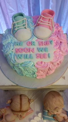 there is a cake with baby shoes on it and the words be or she soon we will be