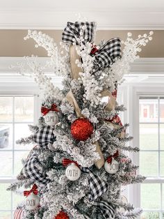 a christmas tree decorated with red, white and black ornaments