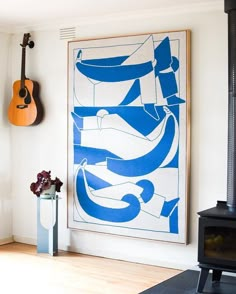 a blue and white painting hanging on the wall