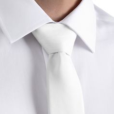 A solid white necktie symbolizes purity and perfection. The KT White necktie provides unyielding elegance and sophistication. Modern Standard Tie For Office, White Fitted Suit And Tie Accessories For Formal Occasions, Elegant White Ties For Workwear, Elegant White Ties For Work, White Tie For Work, White Standard Tie For Work, Classic Solid Ties For Work, Classic Solid Ties For Workwear, White Neckwear With Ties For Work