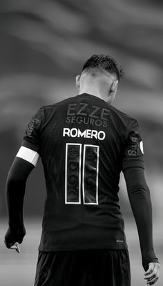 the back of a soccer player's shirt with his hands on his hips,