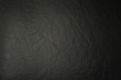 a black leather textured background or wallpaper that looks like it could be used as a backdrop