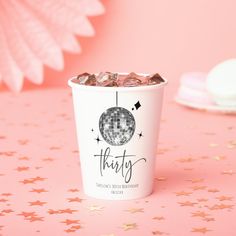 a pink and white cup filled with chocolate chips