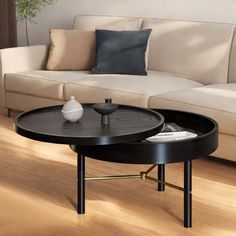 a coffee table sitting on top of a wooden floor in front of a white couch