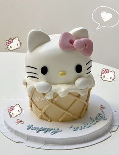 a hello kitty ice cream cone cake on a table