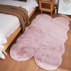 a pink rug on the floor in a bedroom