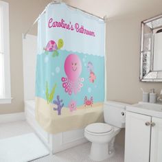 a bathroom with a shower curtain that has an octopus and sea animals on it in the water