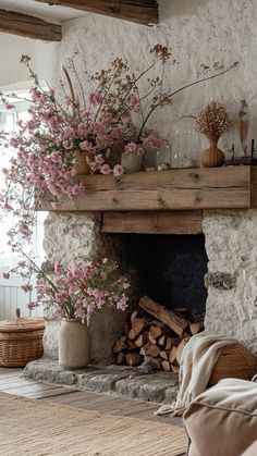 a living room filled with furniture and a fire place covered in lots of pink flowers