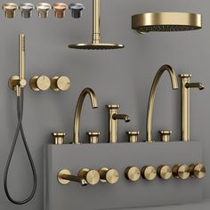 a bathroom with various faucets and shower heads