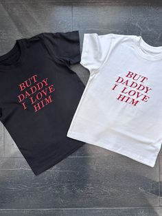 White baby tee with red 'BUT DADDY I LOVE HIM' text Also available in black 100% cotton Model is wearing  size S and is a 6/8 - For reference, model is 5'5 with 31" bust and 26" waist Composition & Care Instructions 100% Combed Ring Spun Cotton; Suitable for 40oC machine wash and tumble dry Cute Black Unisex T-shirt, Cute Unisex Black T-shirt, Black Tops With Funny Text For Family Matching, Black Family Matching Tops With Text Print, Black Family Matching Tops With Funny Text, Unisex Black Tops With Name Print, Family Matching Red Tops With Letter Print, Family Matching Letter Print T-shirt For Streetwear, Red Cotton Tops With Name Print