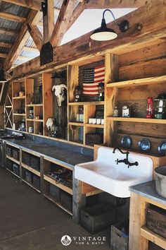 an old fashioned kitchen with wooden shelves and sinks in the center is filled with items