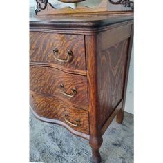 a wooden dresser with two drawers and a mirror on top