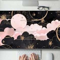 a person typing on a computer keyboard in front of a wall with clouds and stars