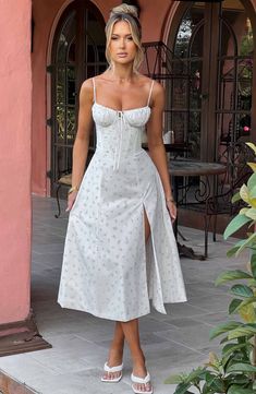 The dreamy Deanna dress is ultra feminine, made in our premium woven cotton blend fabric that feels as good as it looks. With a corseted bodice to cinch the waist, the bust is gathered with a drawstring tie for a super pretty finish. The midi skirt is complete with a thigh high split for a little bit of sexiness. Style it up with an effortless knot and heeled mules.



Colour: Blush Floral Print.

Premium woven cotton blend fabric.

Corseted bodice.

Gathered bust.

Drawstring at the bust.

Thig Homecoming Dresses Corset, Midi Dress Wedding Guest, Dresses Flowy, Ultra Feminine, Maxi Dress Sale, Sparkle Dress, Dresses By Length, Formal Dresses Prom, Flowy Dress