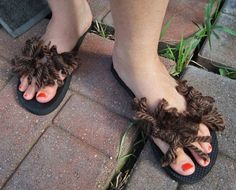 a woman's feet wearing sandals with fuzzy brown slippers on top of them