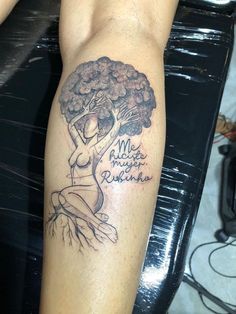 a woman's arm with a tree tattoo on it