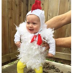 a baby dressed up in a chicken costume