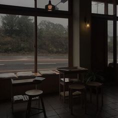 an empty restaurant with large windows overlooking the street