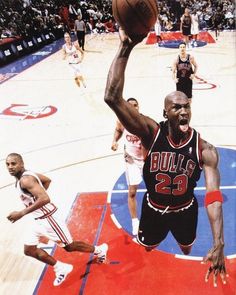 an image of a basketball player going up for the basket in front of other players