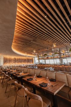 an empty restaurant with wooden tables and chairs