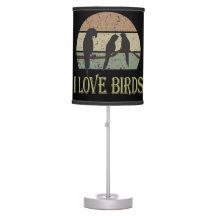 a lamp that is on top of a white stand with a bird and the words i love birds