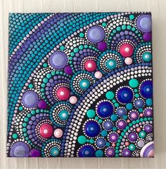 an abstract painting on canvas with dots and circles