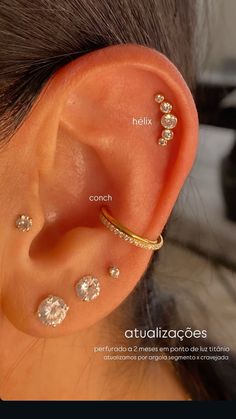 an ear with three different types of piercings on the top and bottom of it