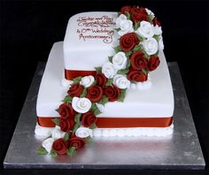 a white cake with red and white flowers on it