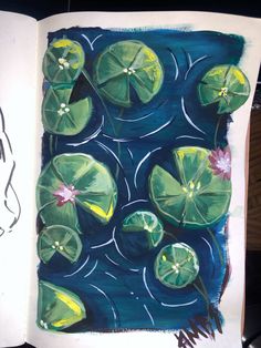 an open book with water lilies on it