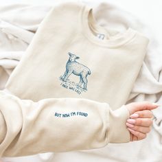 I Once was Lost but Now I'm Found Sweatshirt, Sheep Bible Verse Sleeve Print Shirt, Christian Crewneck, He Left the 99 to Rescue Me Shirt If you are looking for a subtle Christian gift for a believer or for yourself this crewneck is perfect for you! It is made from a durable and soft blend of cotton and polyester, ensuring longevity and comfort. Thank you for taking a chance on my small business! ♦ Dark design on Ash, Sand, Light Blue, Light Pink, and White. All other colors have a light design. Bible T Shirt Design, Left The 99 For The 1, Cool Christian Tshirts, T Shirt Design Christian, Christian Crewneck Sweatshirt, Christian Shirt Design Ideas, Christian Merch Aesthetic, Sweatshirt Designs Vinyl, Christian Sweatshirt Designs