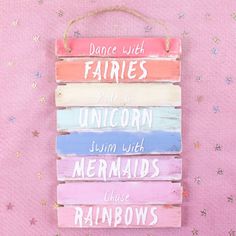 a wooden sign that says dance with fairiess, ride a unicorn, swim with mermaids and have rainbows