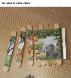 four toothpicks with pictures of animals and giraffes on them sitting on a table