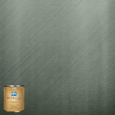 a can of metallic paint next to a brown wall