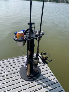 a fishing pole is attached to the back of a boat with two reels on it